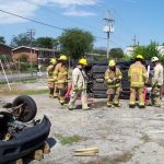 Firemen by Rolled Vehicle