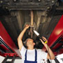mechanic fixing underside of car